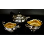 A George III silver three piece tea set, of rectangular form with part fluted body, engraved with