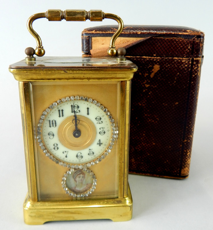 A late 19th/early 20thC French brass carriage clock, with a circular paste set and enamel dial above