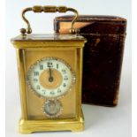 A late 19th/early 20thC French brass carriage clock, with a circular paste set and enamel dial above