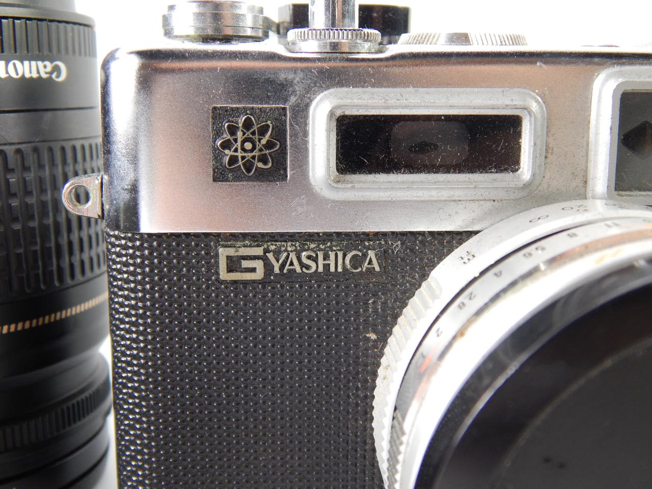 A Yashica G Electro 35 SLR camera, Canon 75-300mm zoom lens, Canon 28-80mm Skylight lens, and Cine - Image 3 of 3