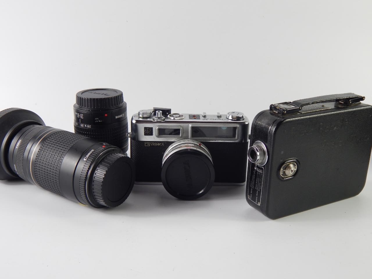 A Yashica G Electro 35 SLR camera, Canon 75-300mm zoom lens, Canon 28-80mm Skylight lens, and Cine