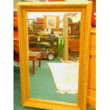 A gilt gesso picture frame, later fitted with a mirror plate, to take a picture sized