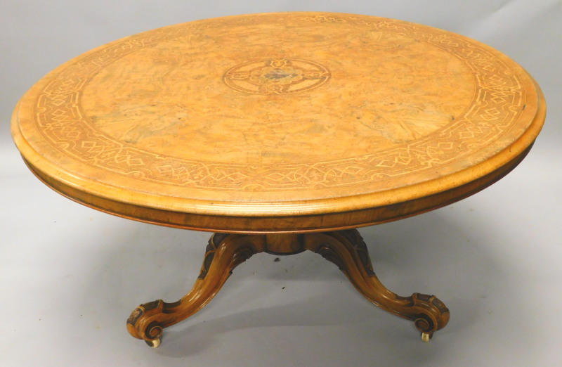 A Victorian figured walnut circular dining table, the quarter veneered top with parquetry roundel,