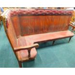 A Victorian mahogany railway waiting room corner bench, with a Rexine padded back and seat, panelled