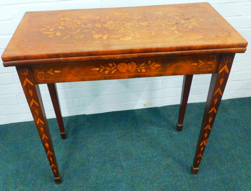 An early 19thC Dutch mahogany and floral marquetry card table, the rectangular top hinged to