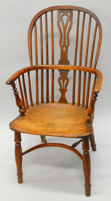 A mid 19thC yew, ash and elm Windsor chair, with a pierced splat, solid seat, on turned legs with