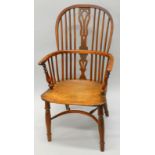 A mid 19thC yew, ash and elm Windsor chair, with a pierced splat, solid seat, on turned legs with