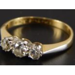 A three stone diamond ring, set in yellow metal, stamped 18ct