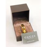 A Gucci gold plated ladies wristwatch, in a fitted case, original retailers card for Fenton Hill