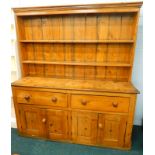 A Victorian and later pine dresser, the back with two plate shelves, the base with an arrangement of