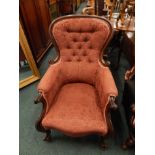 A Victorian mahogany show-frame armchair, with a padded back, armrests and seat, scroll carved