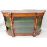 A Victorian figured walnut credenza, the top with a moulded edge and bow fronted end sections, above