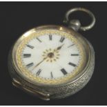 A silver fob watch, with white enamel dial, and gold motifs, in floral engraved case, key wind, 35.