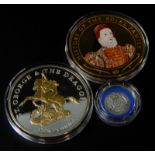 Three collector's coins, to include a Queen Elizabeth II gold plated five ounce History of the Royal