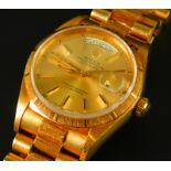 A Rolex Oyster perpetual day date wristwatch, in 18ct gold case, the gold coloured dial with batons,