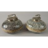 Two table top granite style curling stone inkwells, each of speckled decoration with metal mounts