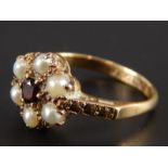 A cluster ring, set with a garnet and seed pearls, in yellow metal mount, stamped 9ct gold