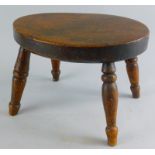 A late 19thC ash and elm stool, the oval top raised on ring turned supports, 18cm high, 28cm wide,