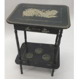 An early 20thC oriental lacquer two tier table, the top decorated with a dragon above a frieze