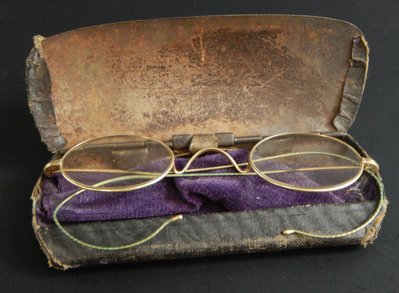 A pair of yellow metal framed spectacles, in fitted case.