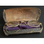 A pair of yellow metal framed spectacles, in fitted case.