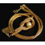 An 18ct gold necklace, of rope twist form, set with central cultured pearl, and drop tassels, 18.