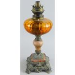 A late 19thC/early 20thC oil lamp, with metal top, inverted ceramic stem and pierced base, with