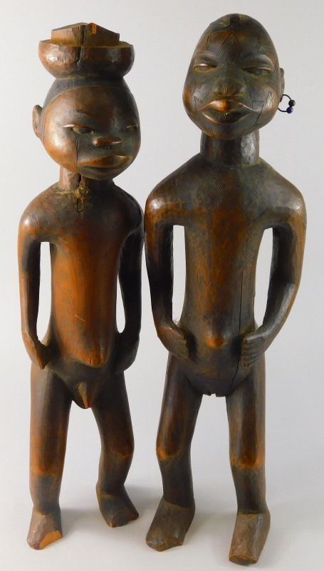Tribal Art. A pair of early 20thC African fertility type figures, the female figure with earrings