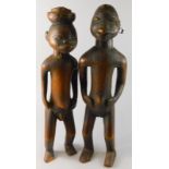 Tribal Art. A pair of early 20thC African fertility type figures, the female figure with earrings