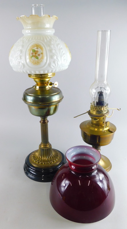 A late 19th/early 20thC brass oil lamp, with milk glass floral shade, clear glass funnel, fluted