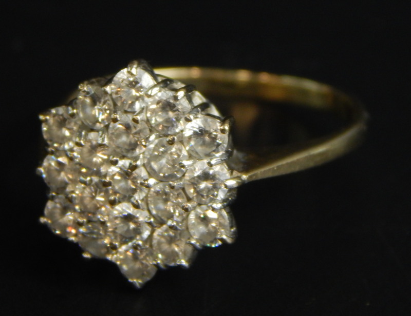 A 9ct gold dress ring, set in a floral cluster, with white stones, 2.3g all in, boxed.