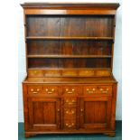 A late 18th/early 19thC oak dresser, the plate rack with tapering sides, flanking two shelves and an