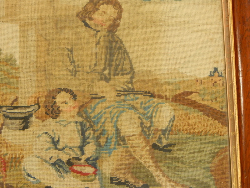 A 19thC woolwork picture, depicting a figure beside a cross, with a young child, two prints of - Image 2 of 2