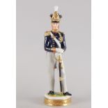 A Kämmer porcelain figure, modelled in the form of a Royal Artillery Officer, in 1828, 24cm high.