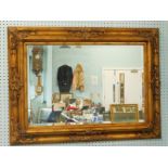 A modern gilt rectangular wall mirror, with bevelled plate, 119cm x 86cm