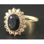 A 9ct gold dress ring, set in a floral cluster with red and white stones, slightly misshapen, 3.5g