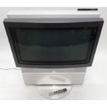 A Bang & Olufsen 30" television, on motorised stand with remote