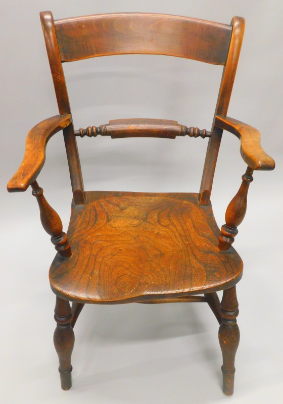 An Oxfordshire bar back Windsor chair, with a part turned rail, shaped arms, solid seat, on turned