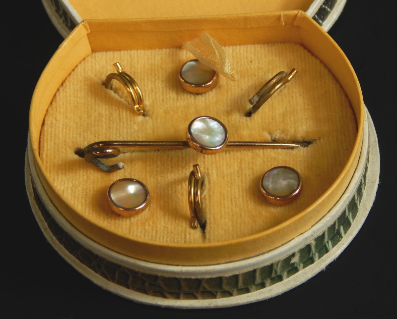 A mother of pearl set collar set, with bar brooch and collar studs, yellow metal, unmarked, boxed.