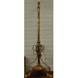 A late 19th/early 20thC adjustable brass standard lamp, with cylindrical column, shaped supports and