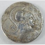 A Greek silver Tetra Drachm, cast to one side with a helmeted Corinthian surrounded by three