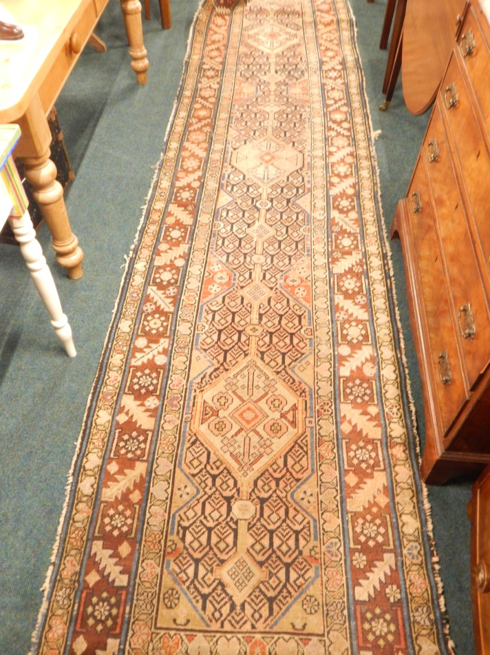 A Persian runner, with an all over design, on a pink ground, with multiple borders 380cm x 90cm - Image 2 of 4