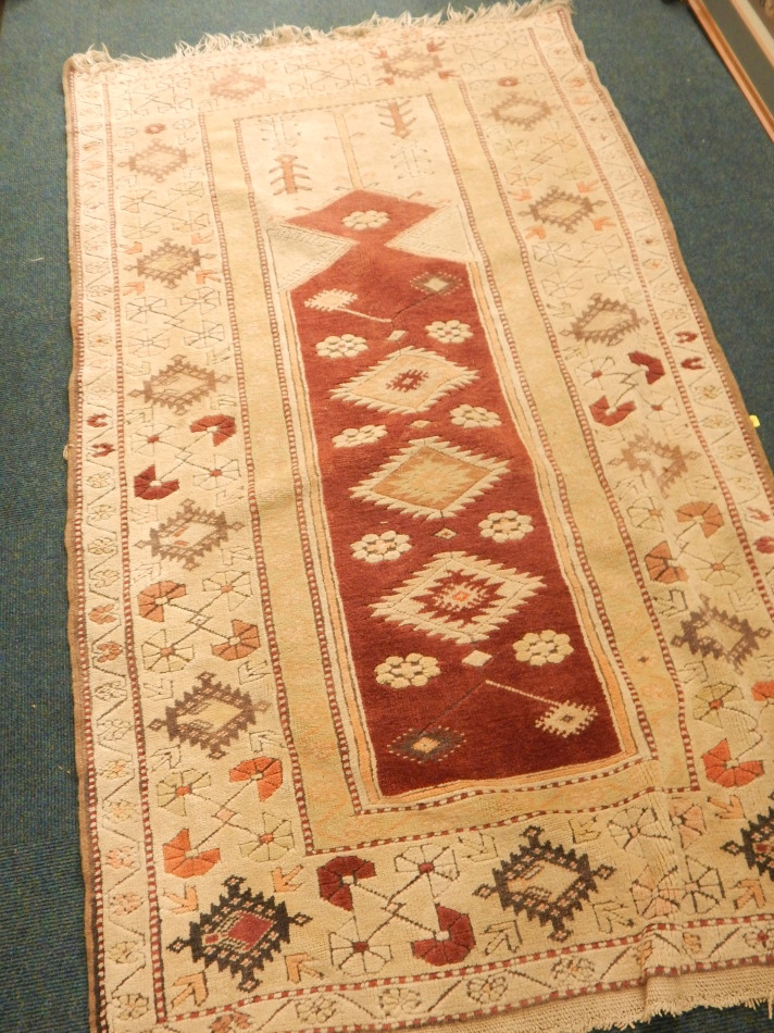 An Anatolian Turkey rug, with a design of medallions, etc, on a red ground, with one wide and two