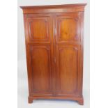 An early 20thC mahogany wardrobe, with two panelled doors on bracket feet, 115cm wide.