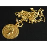 An 18ct gold pendant and chain, the pendant set with an Egyptian figure on a fine link chain, 4.6g