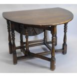 An oak oval gateleg table, on turned supports, 101cm wide.