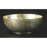 A Middle Eastern white metal bowl, inset with a coin, with chased decoration of flowers etc., 1½ozs,