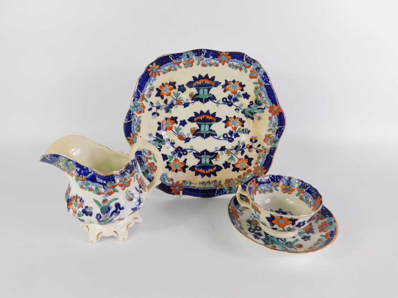 A Staffordshire mid 19thC part tea service imari decorated with flowers, comprising cream jug, bread