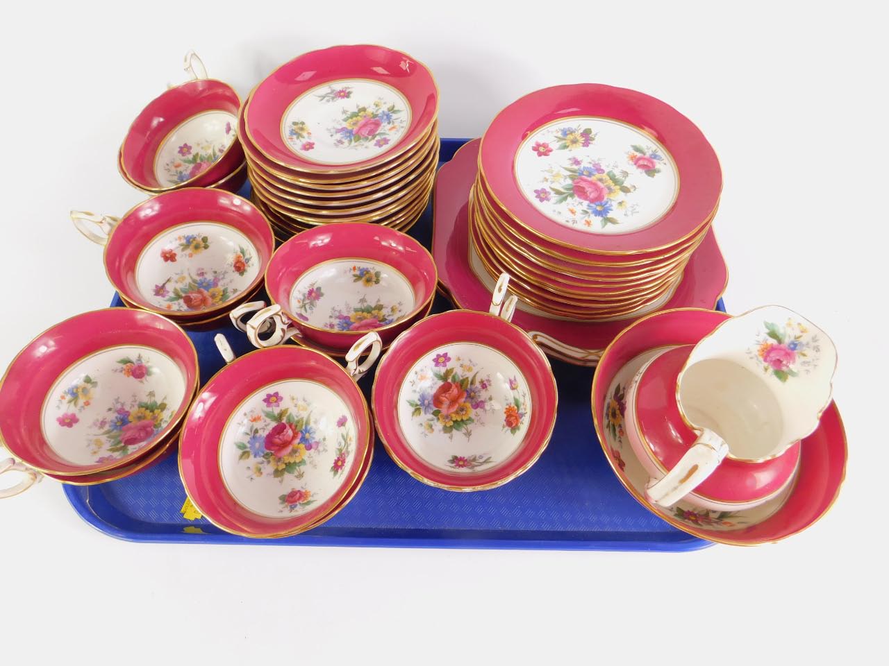 An early 20thC porcelain tea service printed with floral sprays, within a burgundy border, - Image 2 of 2