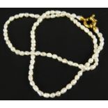 A natural pearl necklace, set with small pearls each approx 3mm, with a yellow metal clasp,
